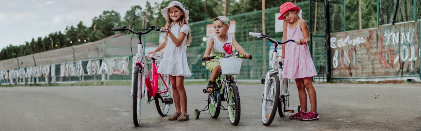 Lapset leikkivät polkupyörillä ulkona.
